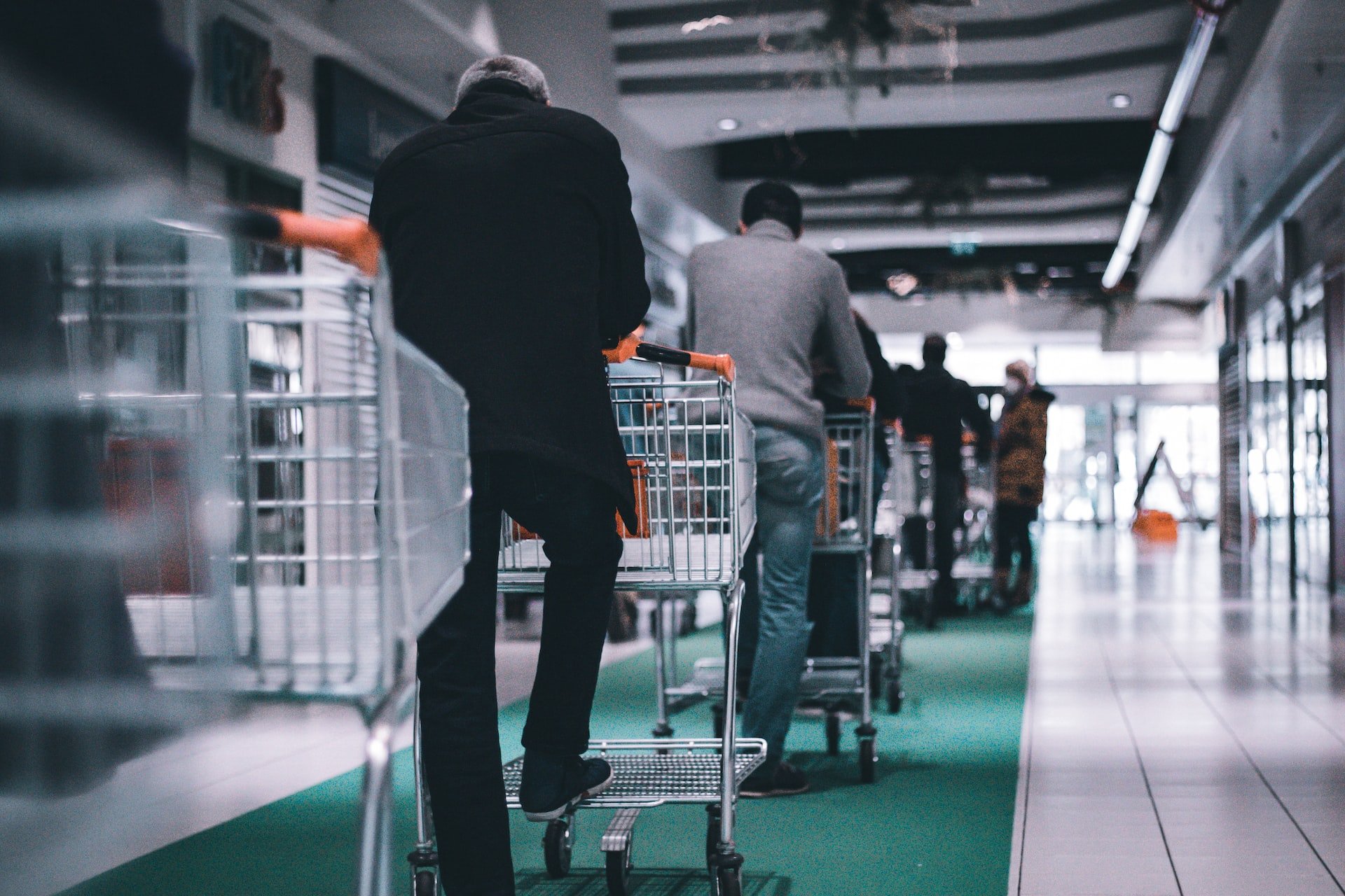 Queue of individuals standing with carts