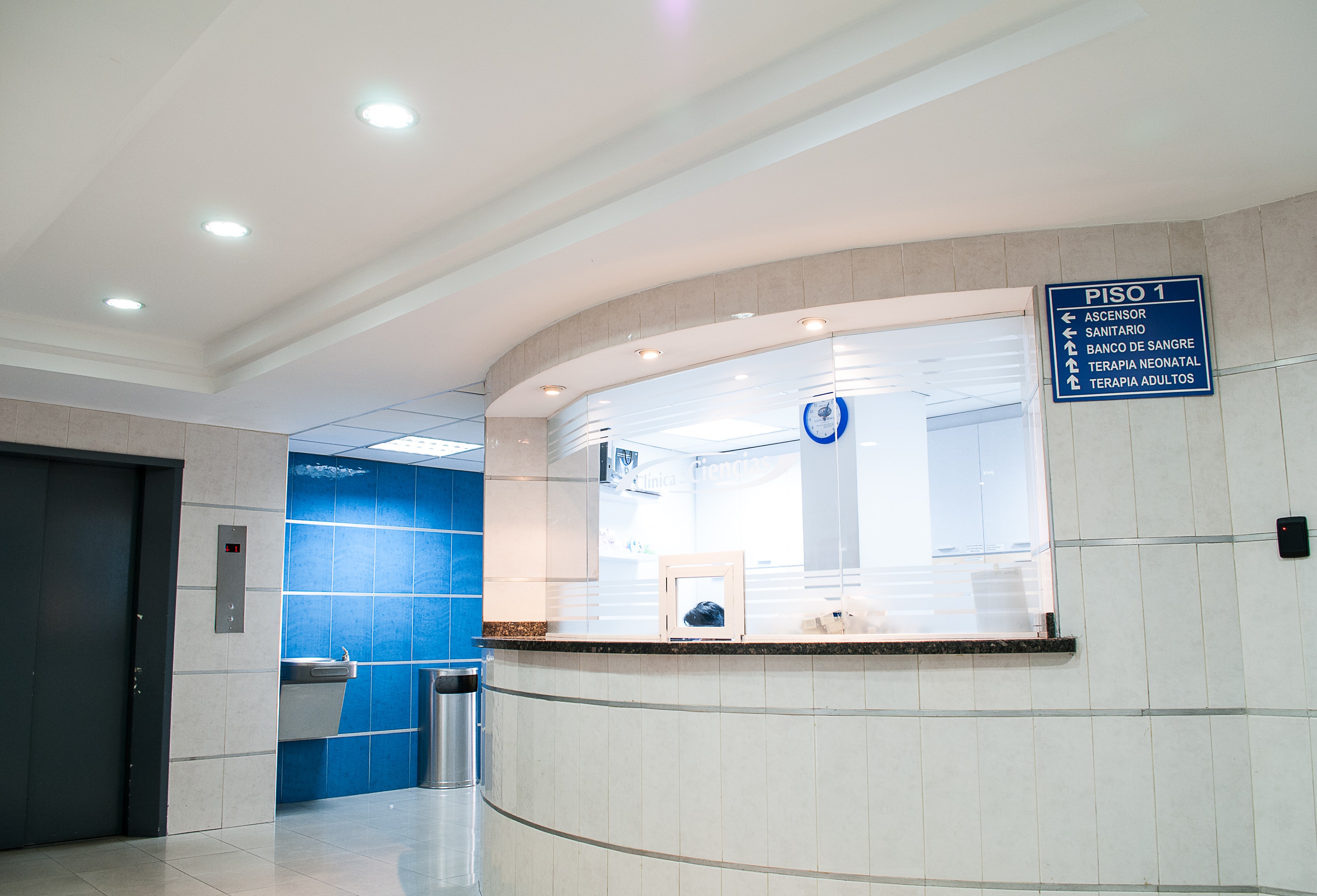 Hospital front desk and lobby area with blue wall