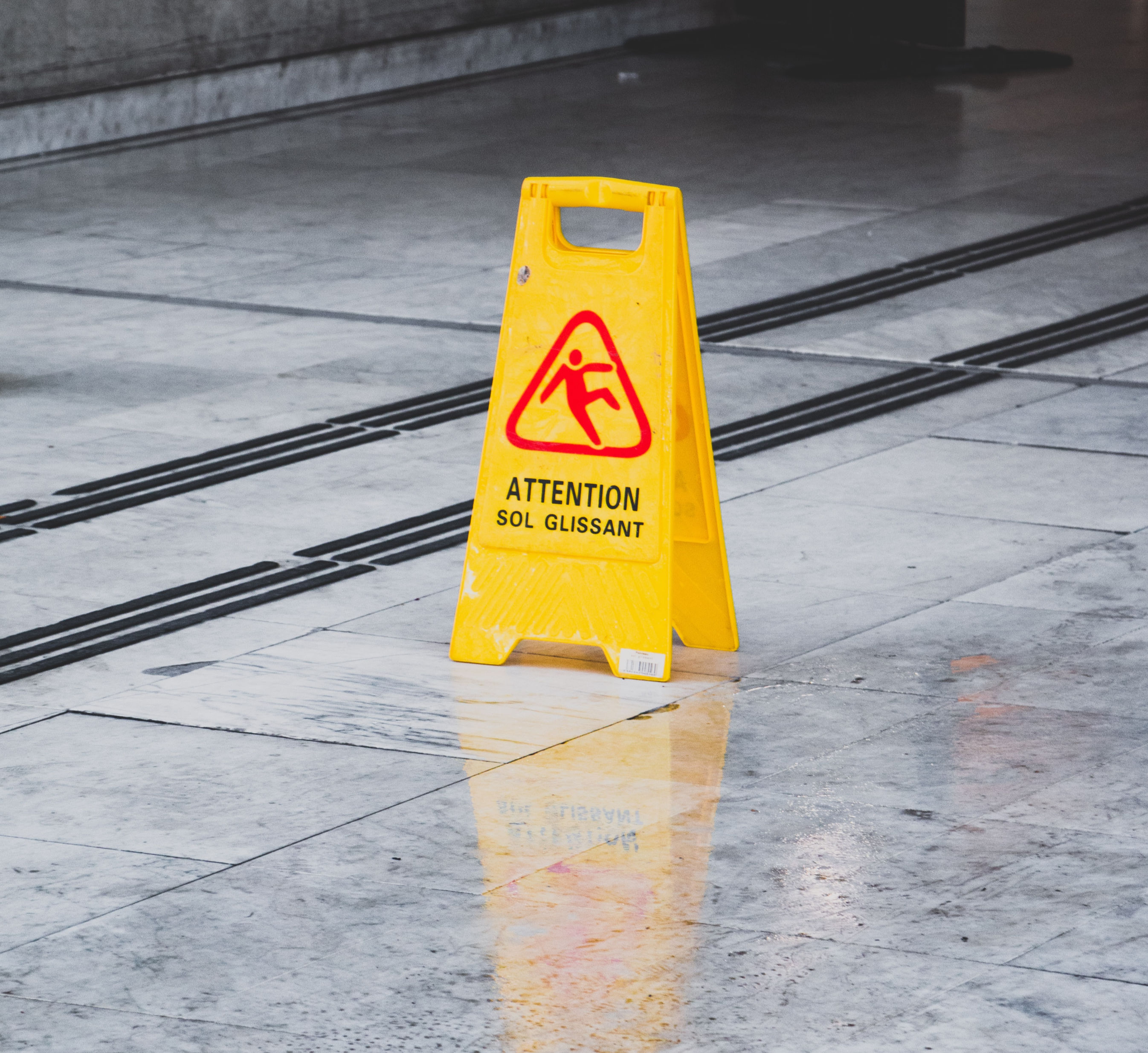 Caution - Slippery When Wet sign on floor. 
